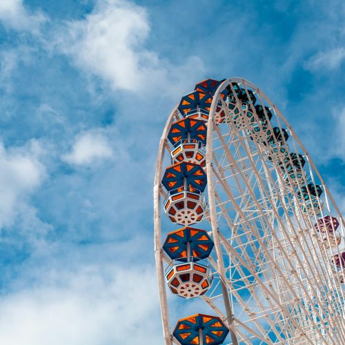 Ferris wheel in an amusement park. Blue sky. Copy space