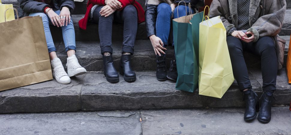 Happy female group of friends doing shopping together