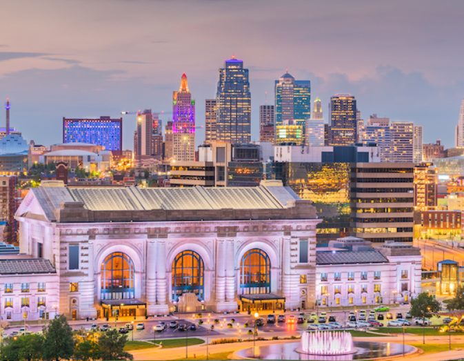 Kansas City, Missouri, USA downtown skyline with Union Station at dusk.